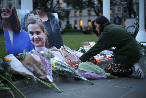 Floral tributes and candles are placed by a picture of slain Labour MP Jo Cox at a vigil in Parliament square in London on June 16, 2016. Cox died today after a shock daylight street attack, throwing campaigning for the referendum on Britain's membership of the European Union into disarray just a week before the crucial vote. / AFP / DANIEL LEAL-OLIVAS (Photo credit should read DANIEL LEAL-OLIVAS/AFP/Getty Images)